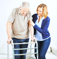 caretaker helping her patient on his crutches 