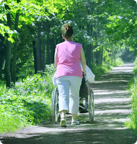 caretaker roam around with her patient on wheelchair